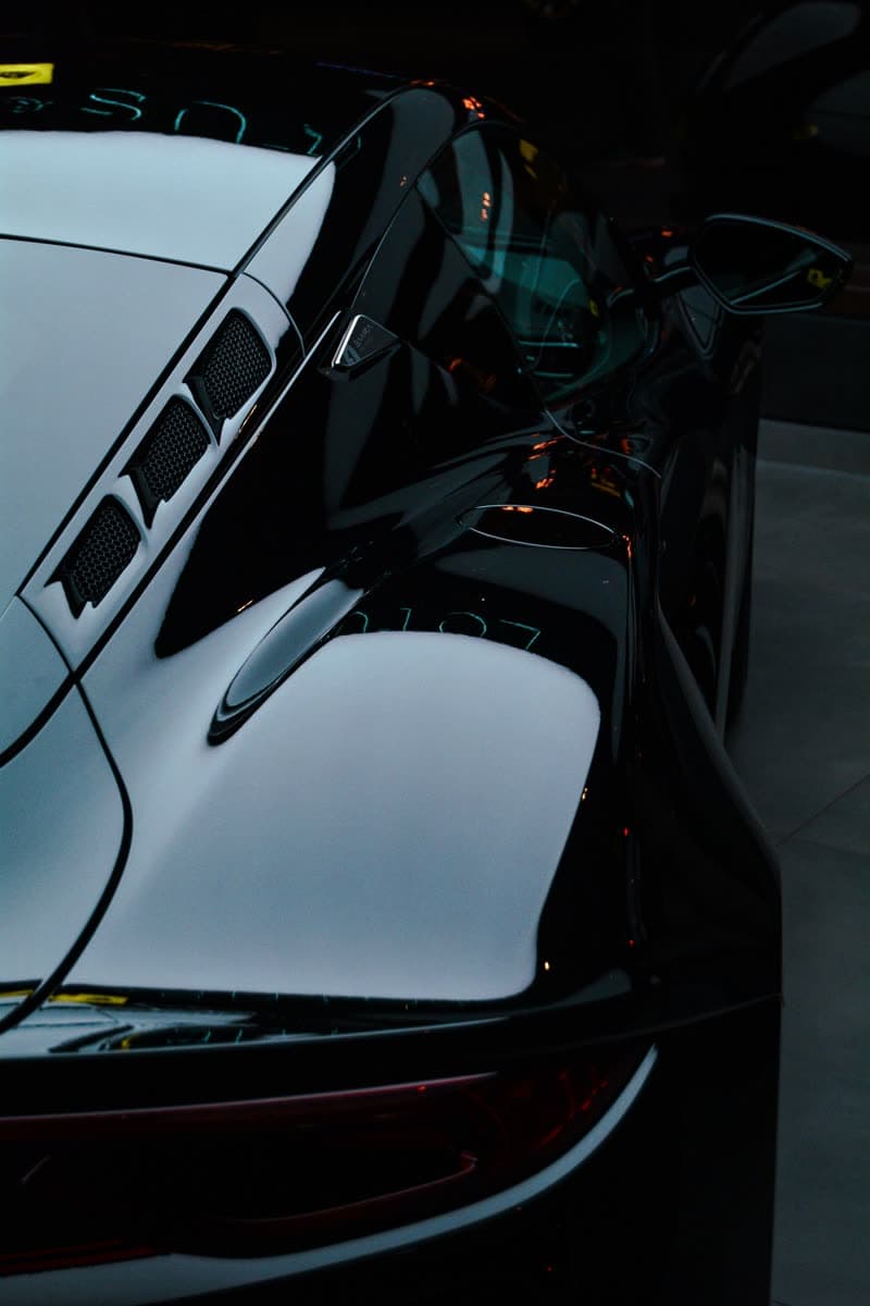 Glossy black paint reflecting overhead light