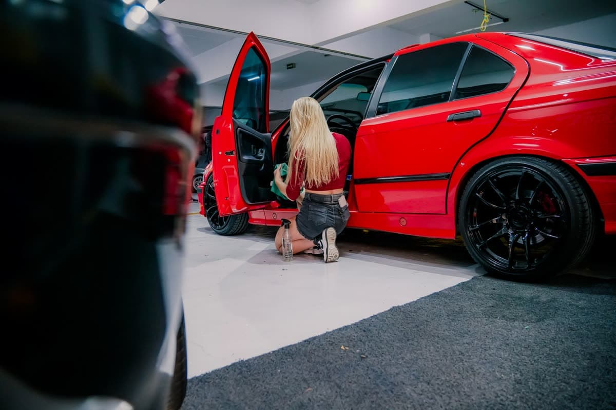 Car cabin interior being cleaned by hand