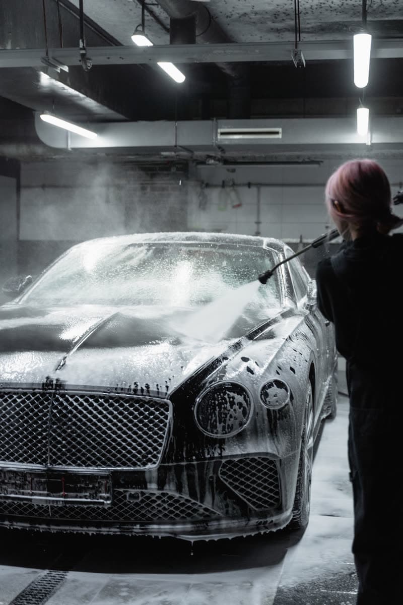 Snow foam covering a black car during a safe-touch wash
