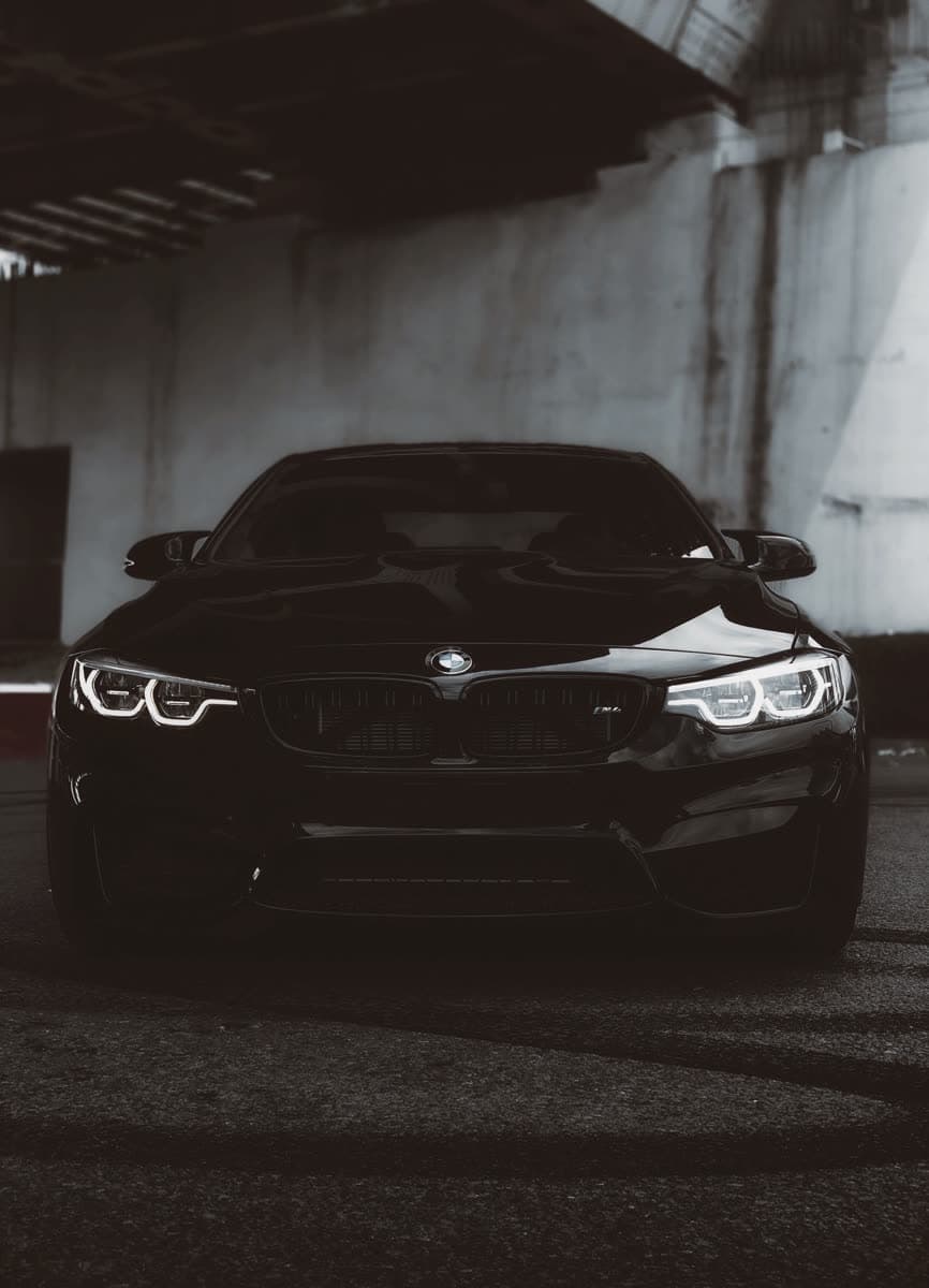 Black BMW M4 under low light